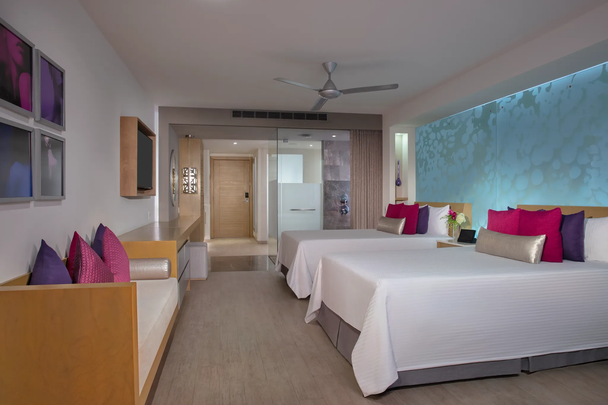 Xcelerate Junior Suite Ocean View at Breathless Riviera Cancun with two beds, modern décor, vibrant accent pillows, and open-concept layout.