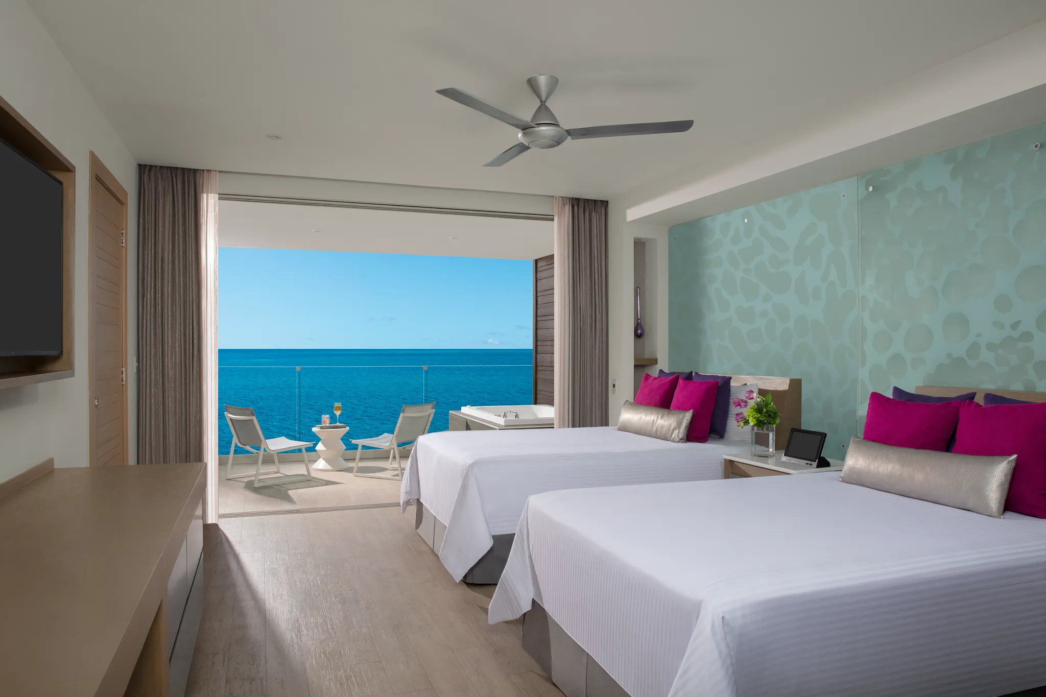 Double-bed layout in the Xhale Club Junior Suite Ocean Front Whirlpool at Breathless Riviera Cancun with oceanfront terrace and whirlpool.