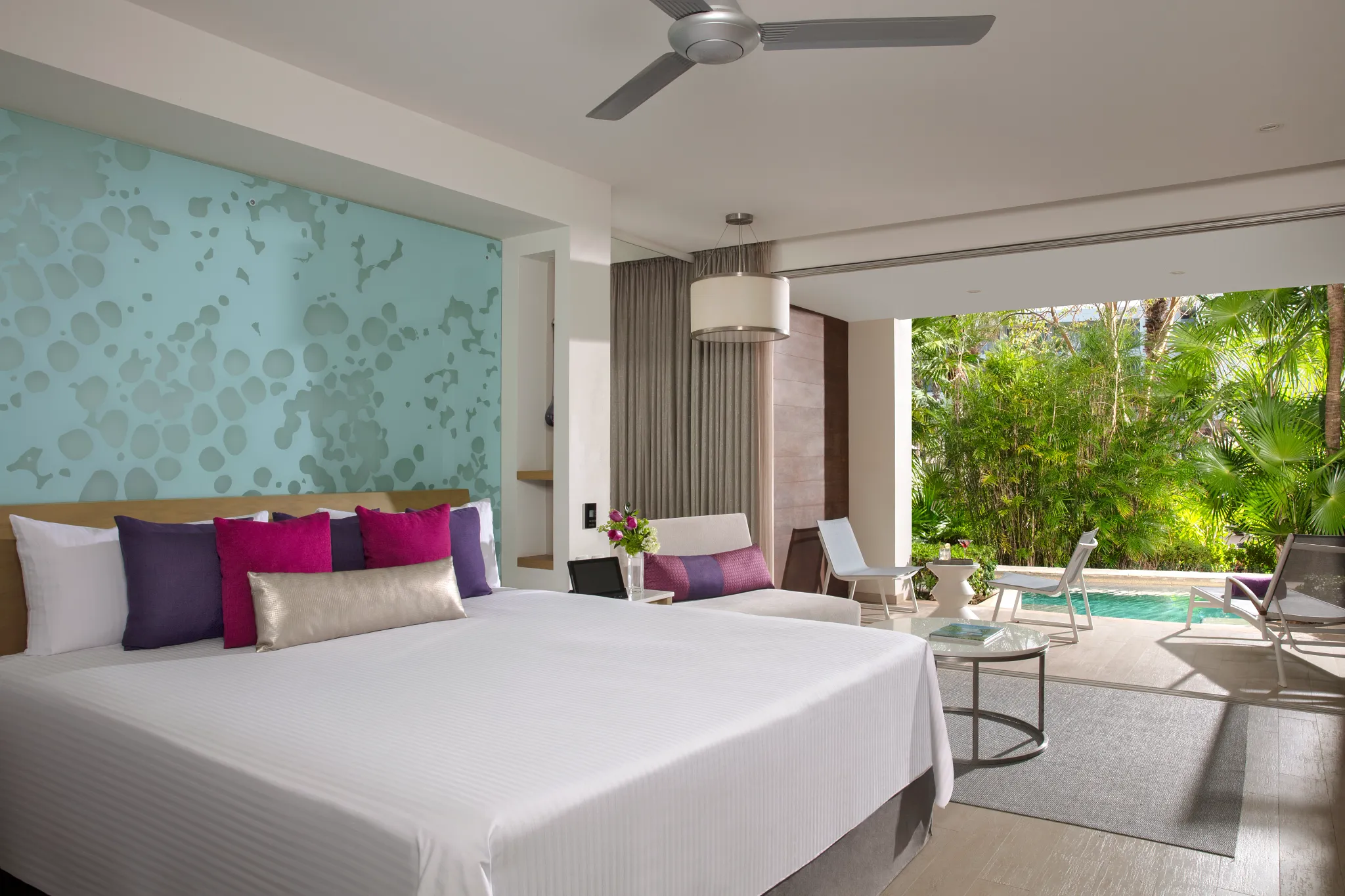 Xhale Club Junior Suite Swim Out Tropical View at Breathless Riviera Cancun with king bed, modern decor, and sliding doors to the swim-out pool.