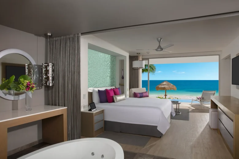 Xhale Club Master Suite Swim Out Ocean Front at Breathless Riviera Cancun with king bed, direct swim-out access, and panoramic Caribbean Sea views.